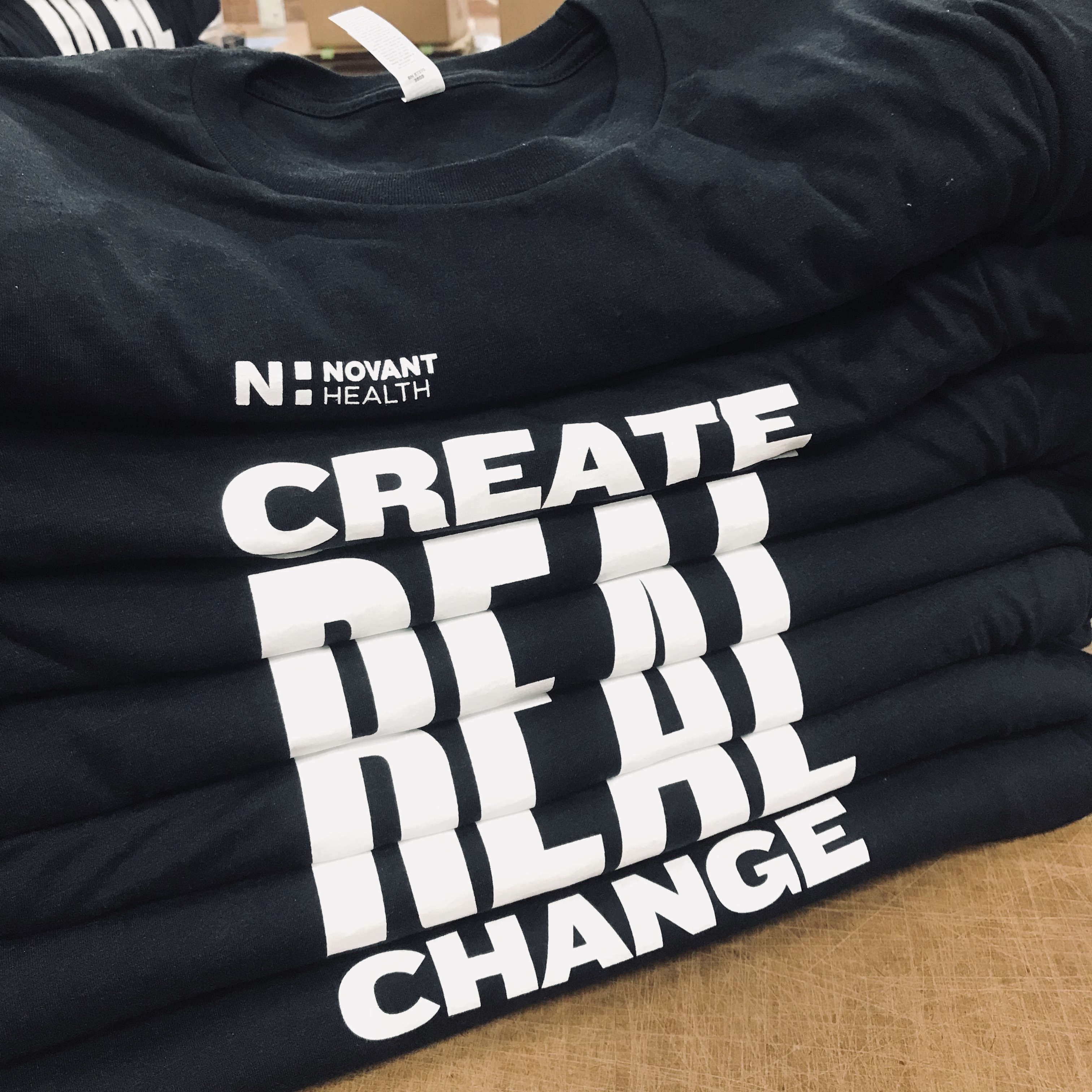 Novant Health Create Real Change custom screen printed tees stacked